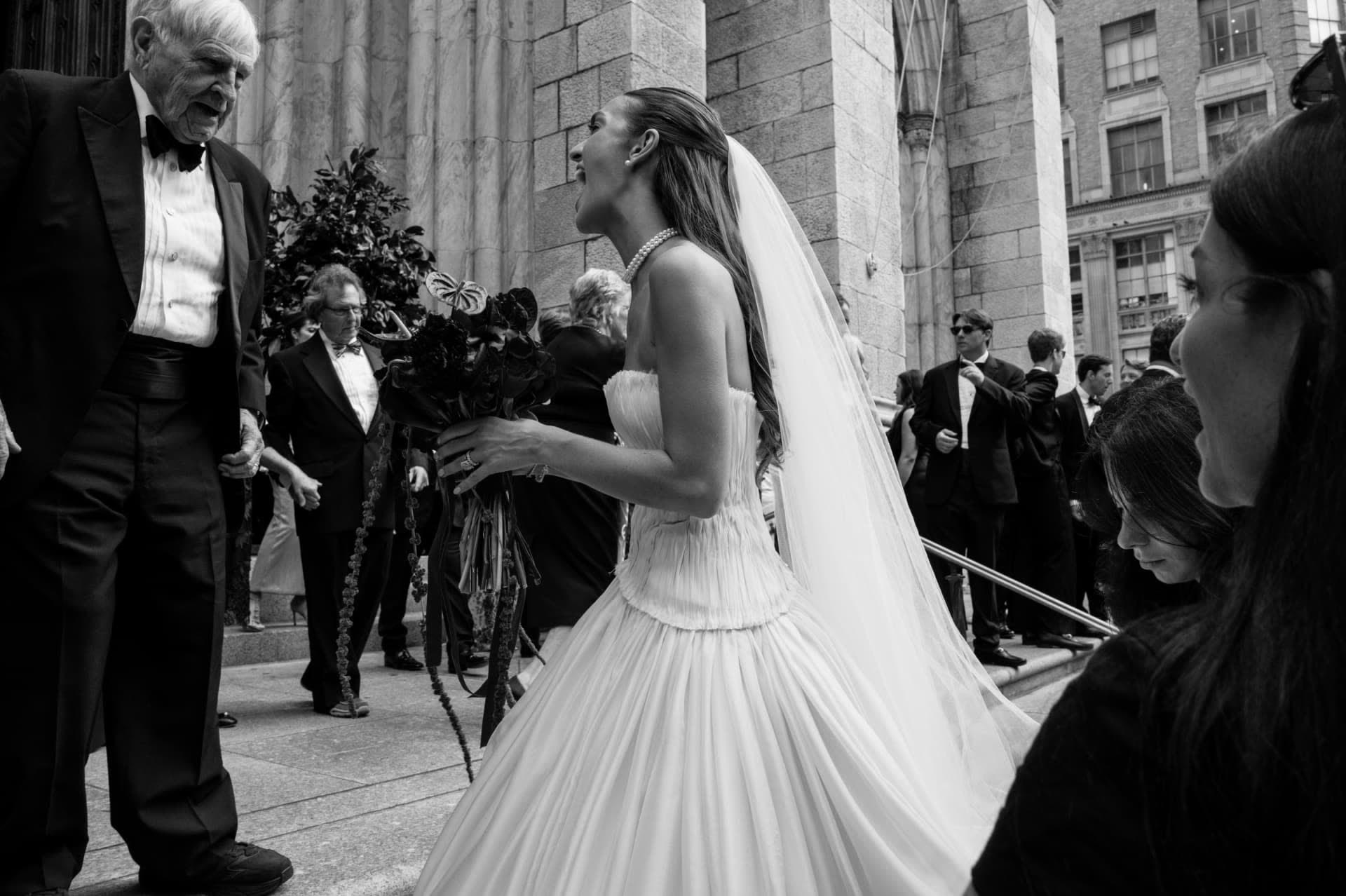 Bride greeting a guest on cathedral steps